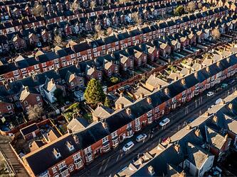 aerial view of red brick houses, streets and cars in england